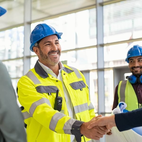 mature-architect-and-contractor-shaking-hands-at-construction-site.jpg